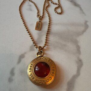 Coach Logo Pendant In Gold Tone Amber Glass Center on Gold Tone Chain